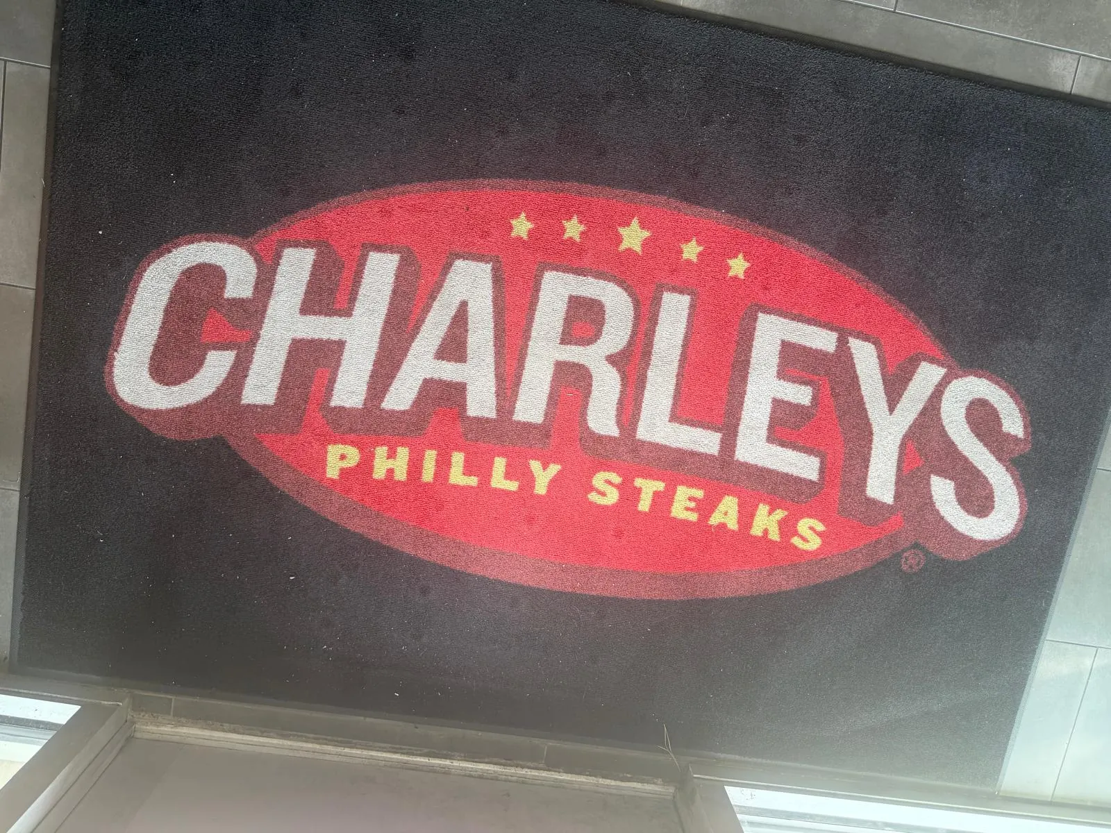 Charleys Philly Steaks logo on a floor mat