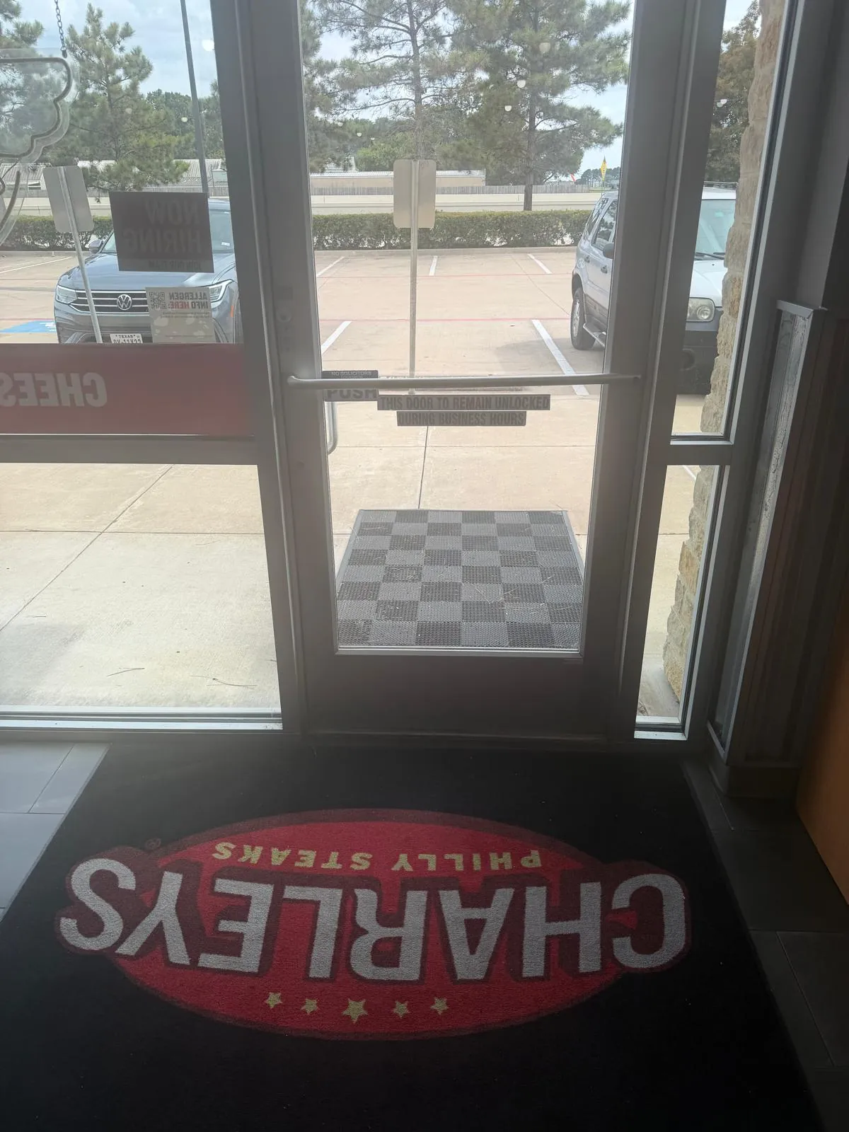 Restaurant entrance showing a Charleys floor mat