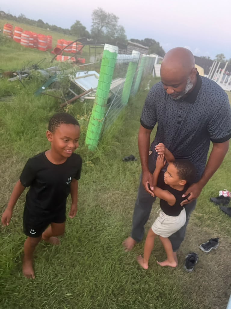 Adult and children spending time together outdoors at the Big Prayer Museum campus
